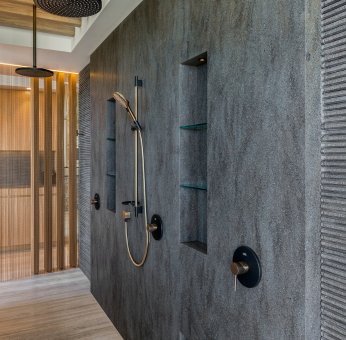 Luxe keuken met een groot Corian&reg; keukenblad in een marmerlook, inclusief kookplaat en moderne inrichting met veel natuurlijk licht.